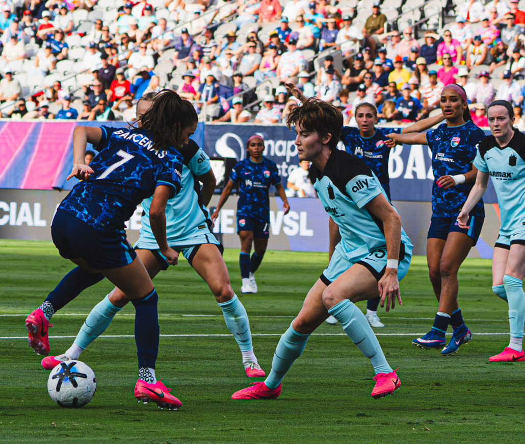 A player executing a sliding tackle on the pitch